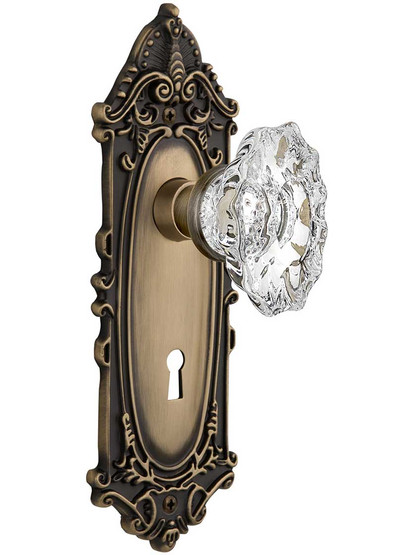 Largo Door Set with Keyhole and Chateau Crystal Glass Knobs in Antique Brass.